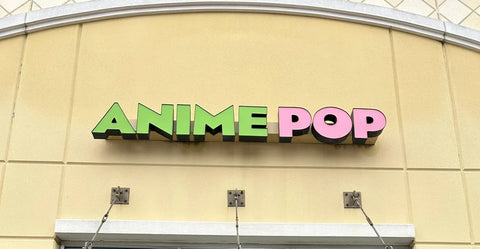 The green and pink Anime Pop sign on the store front